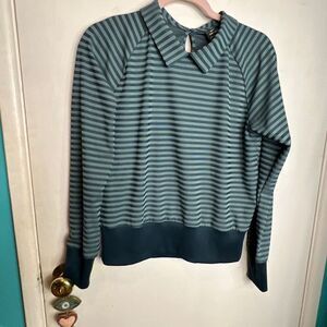 Nike long-sleeved athletic shirt with a striped pattern and collared neckline.